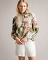 LUUCIAA-Tops-Introducing your new go-to blouse, LUUCIAA. Featuring our botanical scene print and elegant ladder lace inserts, this blouse has everything you need to make a statement. Keep it loose for a laidback attitude or tuck it into your trousers for a sleek style.This product is made with European Flax. It is farmed using no irrigation and no pesticides, helping to reduce water and chemical usage. Long sleeved blouse Botanical scene print Ladder lace inserts 100% linen Stand collar with keyhole cut-out